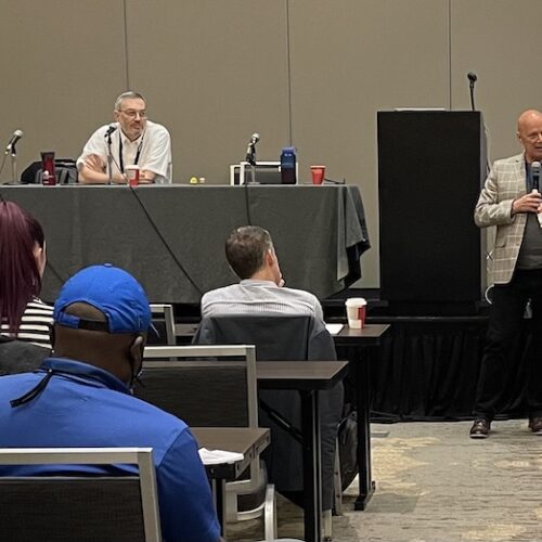 Professionals listening to a presentation.