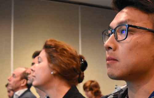 Group of professionals listening to a presentation.