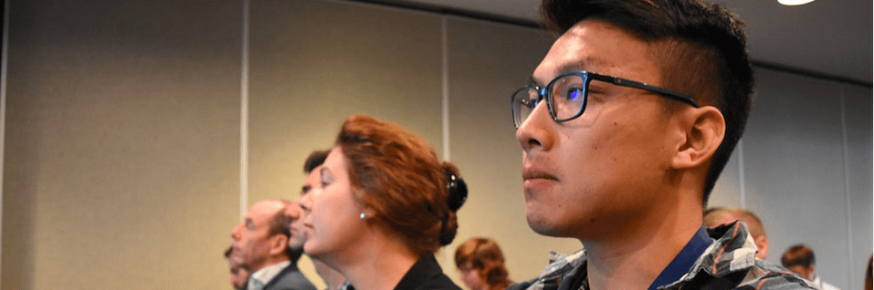 Group of professionals listening to a presentation.