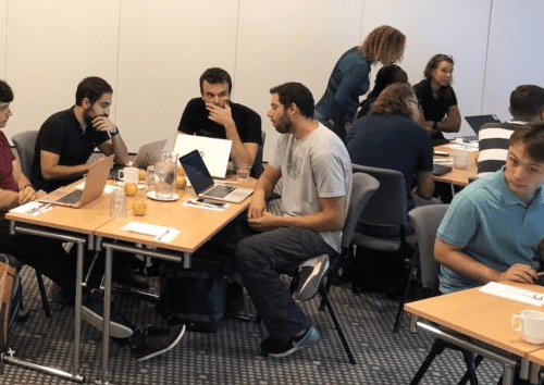 Group of students in a classroom discussing topics