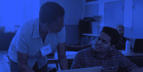 Photo of a woman and man working on a laptop